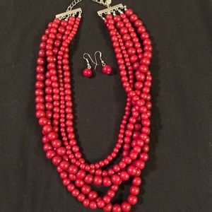 Red multi strand beads with red earrings